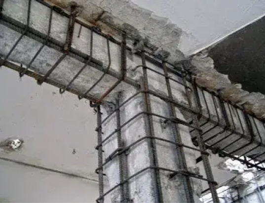 Exposed structural work behind a ceiling