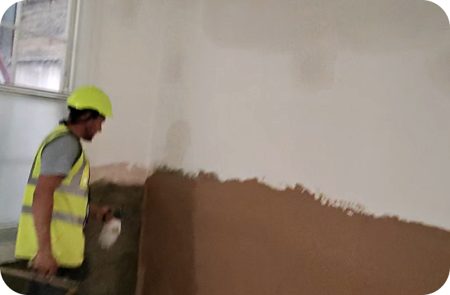 Tradesperson applying TimberArmour to a wall